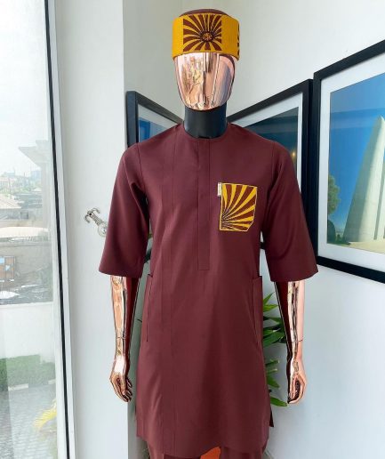 A Cinnamon brown, sunset in the east embroidery detailing hat and patch pocket traditional senator kaftan native.