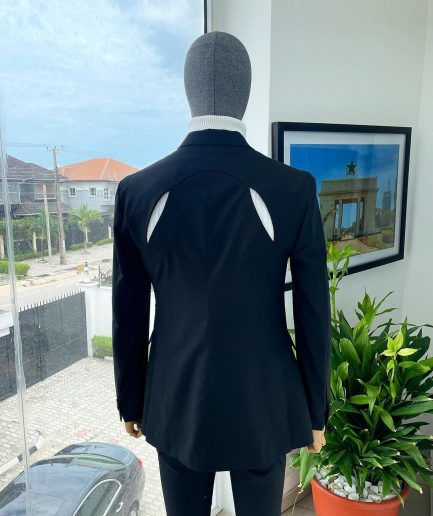 A “power” front and back slit charcoal black, long cross strap peak lapel suit
