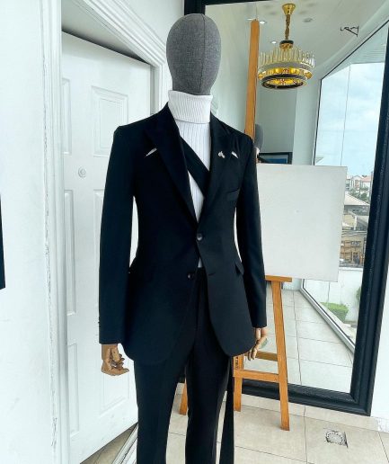 A “power” front and back slit charcoal black, long cross strap peak lapel suit