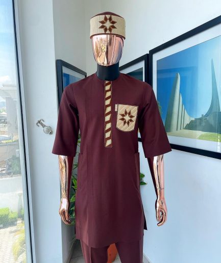 A cinnamon brown, sunrise in the east embroidery detailing hat & patch pocket traditional senator kaftan native.