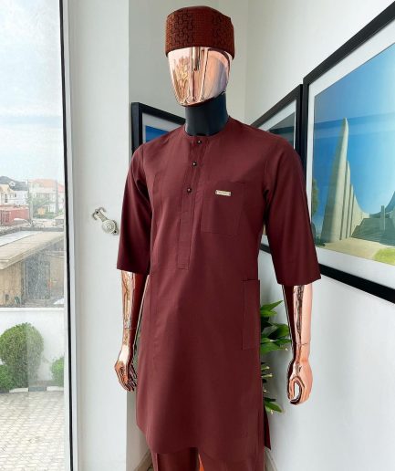 A cinnamon brown 3/4 sleeve kaftan, Swarovski buttons, flap, and spiral binding embroidery hat detailing traditional senator kaftan native