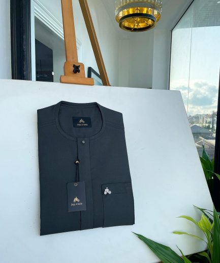 A Phthalo green, front flap and patch pocket with black Swarovski button detailing senator kaftan native.