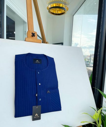 A pencil stripe, navy blue and Skye blue, front flap, blue and clear view Swarovski buttons, patch pocket detailing senator kaftan native.