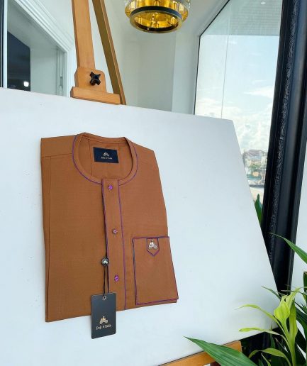 A Tawny brown, front flap, patch pocket, matching Swarovski buttons, paisley detailing African senator kaftan native.