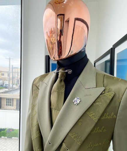A Dark olive green "scritto” (inscribe your name), layered 4 lapels, double-breasted, out-waisted jointed jacket