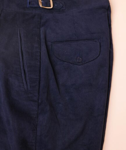 Gurkha trousers with pleats, double side strap buckles, slanted front welt pockets, and a back patch pocket.