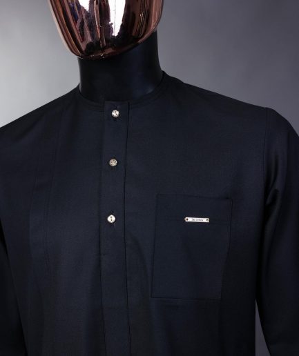 A charcoal black front flap with gold Swarovski buttons, patch pocket, and 3/4 sleeve details African senator kaftan native