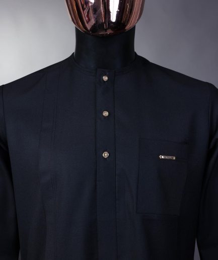 A charcoal black front flap with gold Swarovski buttons, patch pocket, and 3/4 sleeve details African senator kaftan native