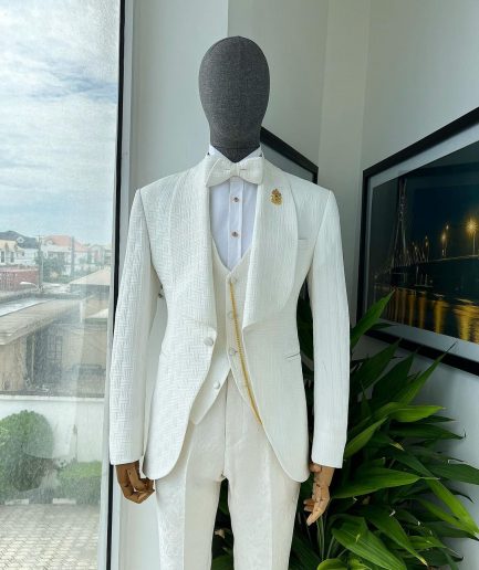 An ivory white, elastic, basket weave layered floral jacquard shawl lapel tuxedo suit.