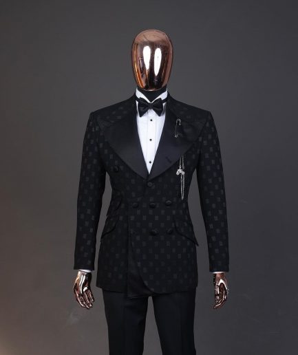 An Inverted “Pirate”, knitted, charcoal black with distributed square pattern jacquard peak lapel, 9 button tuxedo suit.