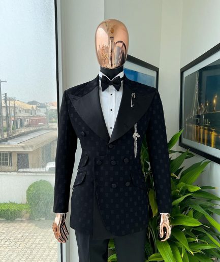 An Inverted “Pirate”, knitted, charcoal black with distributed square pattern jacquard peak lapel, 9 button tuxedo suit.