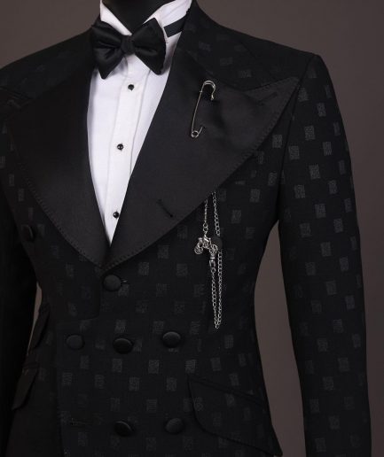 An Inverted “Pirate”, knitted, charcoal black with distributed square pattern jacquard peak lapel, 9 button tuxedo suit.