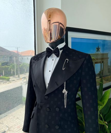 An Inverted “Pirate”, knitted, charcoal black with distributed square pattern jacquard peak lapel, 9 button tuxedo suit.