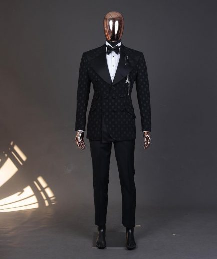 An Inverted “Pirate”, knitted, charcoal black with distributed square pattern jacquard peak lapel, 9 button tuxedo suit.