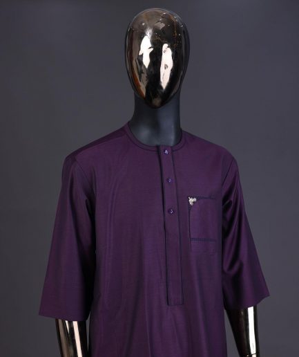 An eggplant purple front flap with matching Swarovski button detailing kaftan and Sokoto