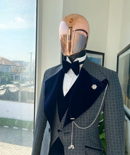 A grey octagonal patterned, navy blue mix, wide notch lapel, single button suit