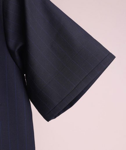 A charcoal black and admiral blue pencil stripe, invisible neckline zip line with layered front flap details, short sleeve African senator kaftan native.