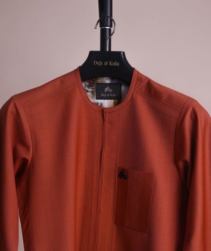 A fire orange and black pencil stripe, zipline, 3/4 sleeve African senator kaftan native.