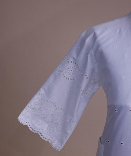A bright white, Swiss patterned lace, front flap with left side pattern, Swarovski button, 3/4 sleeve African kaftan.