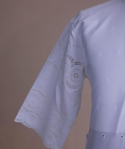 A bright white, Swiss patterned lace, front flap with side pattern, Swarovski button, 3/4 sleeve African kaftan native.