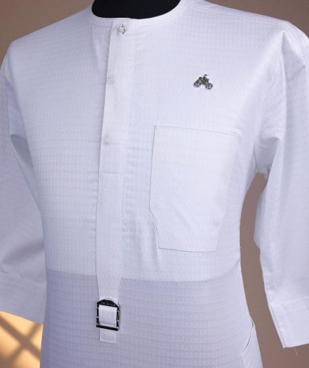 A Bright white, front flap with Swarovski button & metal tag details, 3/4 sleeve African kaftan.