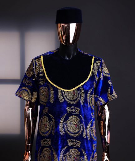 An “isiagu” gold, blue with matching fringe details, short sleeve, hat and velvet pant African traditional native.