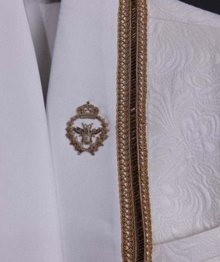 An ivory white floral Jacquard, gold trimmings, patch pocket shawl lapel tuxedo suit
