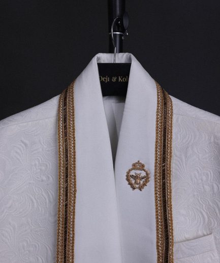 An ivory white floral Jacquard, gold trimmings, patch pocket shawl lapel tuxedo suit