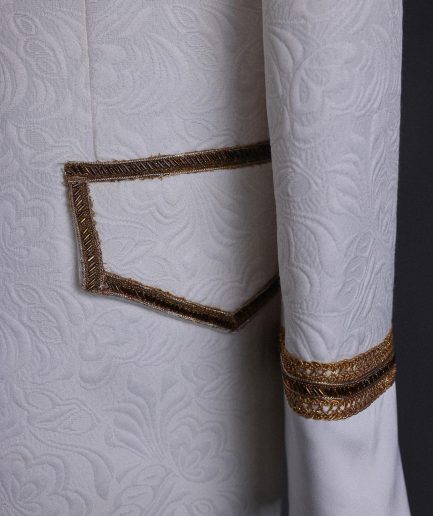 An ivory white floral Jacquard, gold trimmings, patch pocket shawl lapel tuxedo suit