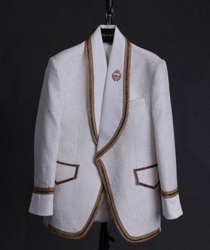 An ivory white floral Jacquard, gold trimmings, patch pocket shawl lapel tuxedo suit