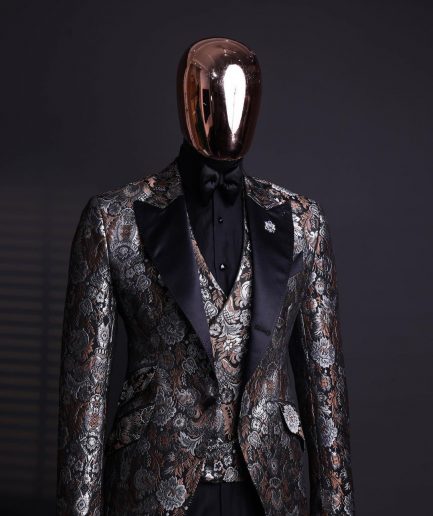 A knitted, brown, silver and black floral jacquard peak lapel suit