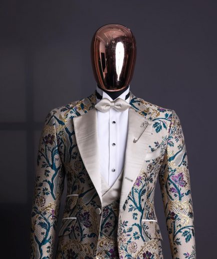 A Tortilla brown, emerald green, gold and splash of burgundy metallic floral jacquard peak lapel tuxedo suit