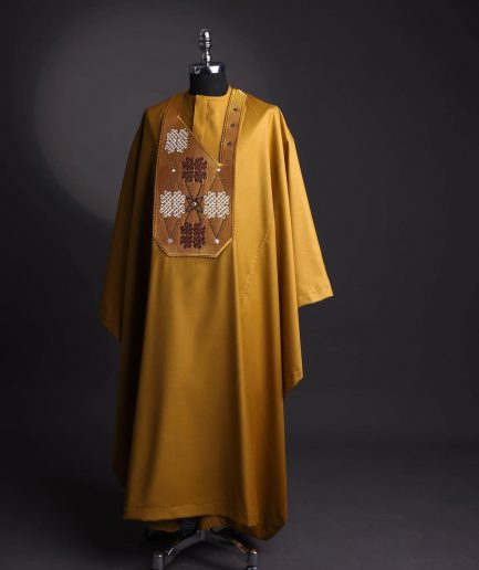 A tawny brown, “connected arewa ” embroidery details with laced Swarovski stone agbada
