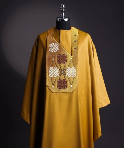 A tawny brown, “connected arewa ” embroidery details with laced Swarovski stone agbada