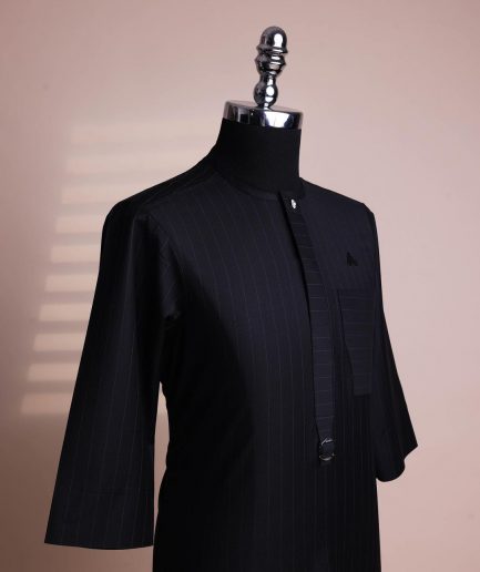 A black pencil stripe, mug-shaped pocket, front flap with buckle strap and silver Swarovski button, 3/4 sleeve African senator kaftan.