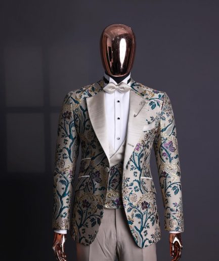 A Tortilla brown, emerald green, gold and splash of burgundy metallic floral jacquard peak lapel tuxedo suit