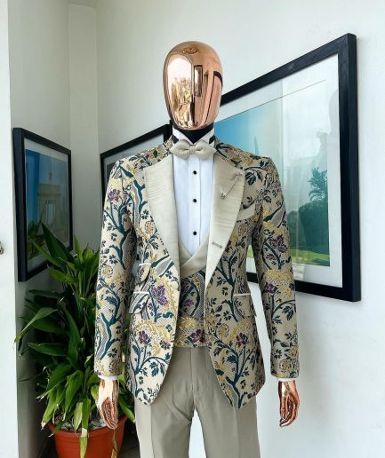 A Tortilla brown, emerald green, gold and splash of burgundy metallic floral jacquard peak lapel tuxedo suit