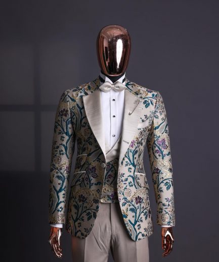 A Tortilla brown, emerald green, gold and splash of burgundy metallic floral jacquard peak lapel tuxedo suit