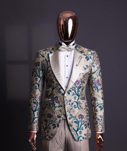 A Tortilla brown, emerald green, gold and splash of burgundy metallic floral jacquard peak lapel tuxedo suit