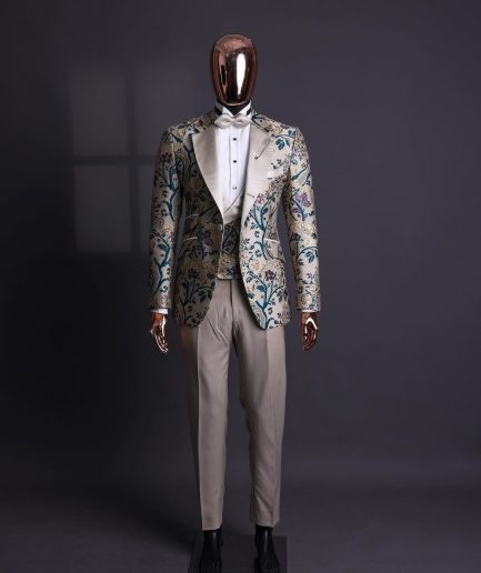 A Tortilla brown, emerald green, gold and splash of burgundy metallic floral jacquard peak lapel tuxedo suit