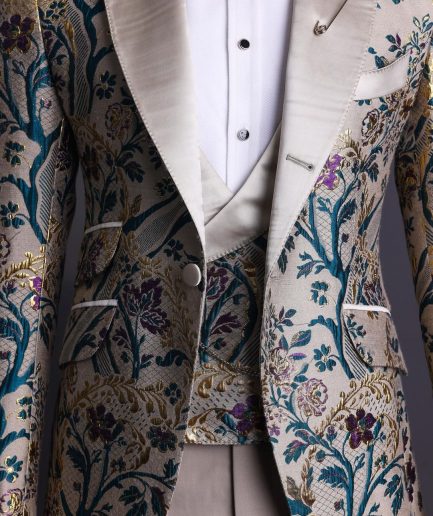 A Tortilla brown, emerald green, gold and splash of burgundy metallic floral jacquard peak lapel tuxedo suit