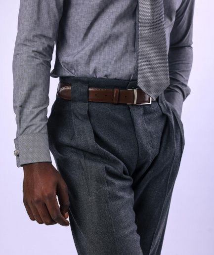A Grey Gurkha pant with a covered belt tab and double pleats.