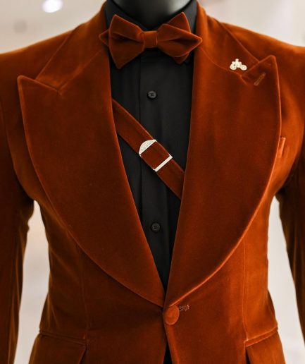 A Syrup Brown, Peak Lapel Tuxedo Suit With An Inner Slant Anchor.