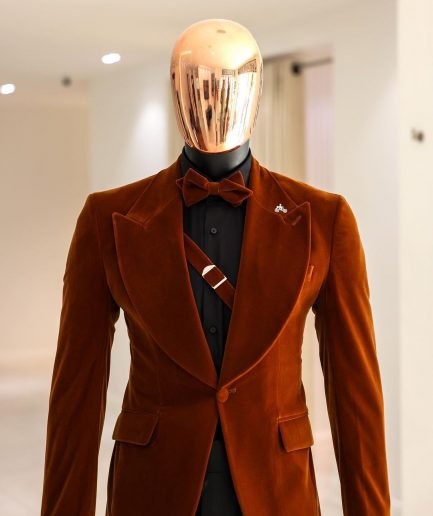A Syrup Brown, Peak Lapel Tuxedo Suit With An Inner Slant Anchor.