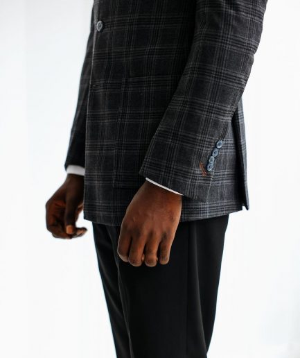 A Charcoal grey, windowpane check, nobility fabric cover coat with patch pocket detailing