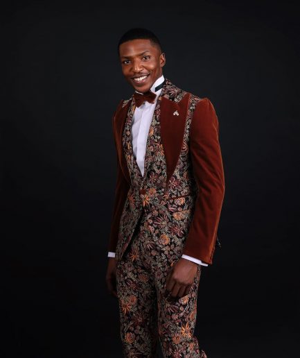 A “Dent” Floral Syrup Brown Metallic Jacquard Peak Quad Lapel Suit, Bow Tie & Gurkha Pant Trousers.