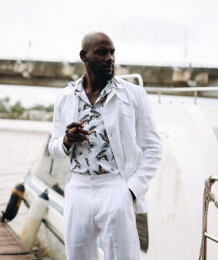 A White “Tropicana” Linen Overcoat & Wide Cut Pant Trousers.
