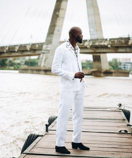 A White “Tropicana” Linen Overcoat & Wide Cut Pant Trousers.