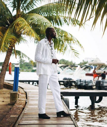 A White “Tropicana” Linen Overcoat & Wide Cut Pant Trousers.