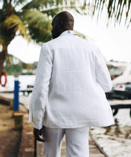 A White “Tropicana” Linen Overcoat & Wide Cut Pant Trousers.